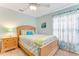 Bedroom featuring mint walls, carpet, ceiling fan and window with floral curtains at 1910 Creekwater Blvd, Port Orange, FL 32128