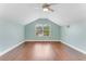 Large bonus room with hardwood flooring, window, and neutral mint walls at 1910 Creekwater Blvd, Port Orange, FL 32128