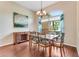 Bright dining room with a chandelier, wood floors, and a large window at 1910 Creekwater Blvd, Port Orange, FL 32128