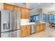 Modern kitchen with stainless steel appliances, quartz counters, and wood cabinets at 1910 Creekwater Blvd, Port Orange, FL 32128