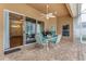 Covered patio with brick pavers, a ceiling fan, and a table with four chairs at 1910 Creekwater Blvd, Port Orange, FL 32128