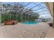 Relaxing screened-in pool area, with a hot tub and brick pavers at 1910 Creekwater Blvd, Port Orange, FL 32128