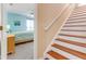 View of bedroom with stairs to the side with wood steps and white risers and rail at 1910 Creekwater Blvd, Port Orange, FL 32128