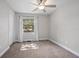 This bedroom features a ceiling fan, a window with curtains, and neutral decor at 2032 Yorkshire Dr, Deland, FL 32724