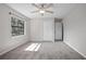 This bedroom boasts a ceiling fan, a window, and a double-door closet for storage at 2032 Yorkshire Dr, Deland, FL 32724