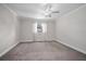 Spacious bedroom featuring neutral carpeting, white trim, and a ceiling fan at 2032 Yorkshire Dr, Deland, FL 32724