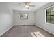 This bedroom features a ceiling fan and ample natural light from the windows at 2032 Yorkshire Dr, Deland, FL 32724