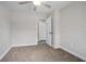 This bedroom showcases neutral walls, a ceiling fan, and two closets at 2032 Yorkshire Dr, Deland, FL 32724