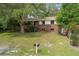 Charming brick two-story home with a well-maintained front yard and mature trees at 2032 Yorkshire Dr, Deland, FL 32724