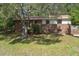 Charming brick two-story home with a well-maintained front yard and mature trees at 2032 Yorkshire Dr, Deland, FL 32724