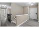 Light and airy hallway with wood-look floors and a charming stair railing at 2032 Yorkshire Dr, Deland, FL 32724