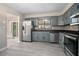 Renovated kitchen with stainless steel appliances, gray cabinets and countertops at 2032 Yorkshire Dr, Deland, FL 32724