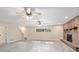 The spacious living room has a brick fireplace and ceiling fans for added comfort at 2032 Yorkshire Dr, Deland, FL 32724