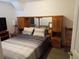 Bedroom featuring a built-in headboard with a mirrored accent, and a queen bed at 20422 Canvas Back Rd, Altoona, FL 32702
