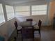 Cozy dining area with a dark wood table and four chairs, bathed in natural light at 20422 Canvas Back Rd, Altoona, FL 32702