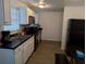 Functional kitchen featuring sleek black appliances, white cabinets, and ample counter space at 20422 Canvas Back Rd, Altoona, FL 32702