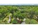 Expansive aerial shot of a secluded property with winding driveway and mature trees at 2221 Oak Hill Dr, Deland, FL 32720