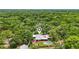 Aerial view of property with house, pool, and marker, enveloped by a dense forest at 2221 Oak Hill Dr, Deland, FL 32720