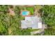 An aerial view of a house featuring a pool, spacious yard, and metal roof at 2221 Oak Hill Dr, Deland, FL 32720