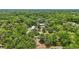 Aerial view of a home nestled within a vibrant green forest, showcasing a private and serene setting at 2221 Oak Hill Dr, Deland, FL 32720