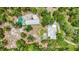 Bird's-eye view of a home with a pool, additional buildings, and a lush, tree-filled property at 2221 Oak Hill Dr, Deland, FL 32720