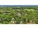Expansive aerial shot of a secluded property with winding driveway and mature trees at 2221 Oak Hill Dr, Deland, FL 32720