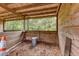 Barn interior showcases wooden walls, wired window, and wood chip flooring, providing a rustic and functional space at 2221 Oak Hill Dr, Deland, FL 32720