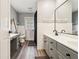 Bright bathroom featuring a double vanity, modern fixtures, and wood-look floors at 2221 Oak Hill Dr, Deland, FL 32720