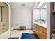 Bright bathroom features a tub/shower combo and double sink vanity at 2221 Oak Hill Dr, Deland, FL 32720
