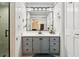 Bright bathroom featuring tiled walls, a gray vanity, and a large mirror at 2221 Oak Hill Dr, Deland, FL 32720