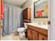 Bathroom with wood vanity, shower, and ample storage cabinet at 2221 Oak Hill Dr, Deland, FL 32720