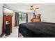 Inviting bedroom with natural lighting, ceiling fan, and modern wood furnishings at 2221 Oak Hill Dr, Deland, FL 32720