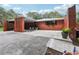 Front exterior of the brick home with a wide driveway and carport at 2221 Oak Hill Dr, Deland, FL 32720