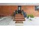 Brick front porch and entryway to the home with potted plants at 2221 Oak Hill Dr, Deland, FL 32720