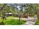 Charming single-story brick home with a metal roof, manicured lawn, and a welcoming entrance at 2221 Oak Hill Dr, Deland, FL 32720