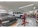 Large garage featuring two vehicles, tools, and ample workspace for automotive enthusiasts at 2221 Oak Hill Dr, Deland, FL 32720