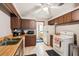 A kitchen with wooden cabinets, white appliances, and vinyl flooring for a blend of functionality and simplicity at 2221 Oak Hill Dr, Deland, FL 32720