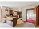 Kitchen offering a breakfast bar and open doorway to a red carpeted staircase at 2221 Oak Hill Dr, Deland, FL 32720