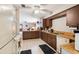 Charming kitchen featuring wood cabinets, a ceiling fan, and an open layout to the living room at 2221 Oak Hill Dr, Deland, FL 32720