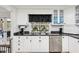 Functional kitchen with white cabinetry, subway backsplash, and stainless dishwasher at 2221 Oak Hill Dr, Deland, FL 32720