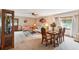 A sun-filled living room offers dining and seating areas with neutral colors and modern decor at 2221 Oak Hill Dr, Deland, FL 32720