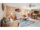 Bright living room featuring plush seating, ceiling fan, and adjacent dining area, perfect for entertaining guests at 2221 Oak Hill Dr, Deland, FL 32720