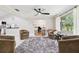 Open-concept living room featuring a ceiling fan and ample seating at 2221 Oak Hill Dr, Deland, FL 32720