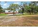 Exterior of an outbuilding with garage doors and a concrete driveway at 2221 Oak Hill Dr, Deland, FL 32720