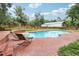 Outdoor pool with lounge chairs surrounded by a brick patio and lush greenery at 2221 Oak Hill Dr, Deland, FL 32720