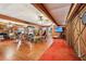 Recreation room boasts wooden floors, ample seating, and a staircase to the main level at 2221 Oak Hill Dr, Deland, FL 32720