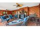 Relaxing sunroom featuring wood paneling, brick floors, and comfortable seating at 2221 Oak Hill Dr, Deland, FL 32720