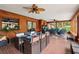 Spacious sunroom boasts wood paneled walls, brick floors, and multiple seating areas at 2221 Oak Hill Dr, Deland, FL 32720