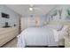 Comfortable bedroom with light blue walls, dresser and ensuite bathroom at 2222 Ocean Shore Blvd # 304B, Ormond Beach, FL 32176