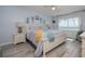 Light and airy bedroom featuring calming blue walls and a beautiful ocean view from the bedside window at 2222 Ocean Shore Blvd # 304B, Ormond Beach, FL 32176
